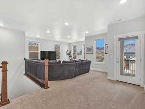 Living room with recessed lighting and light colored carpet