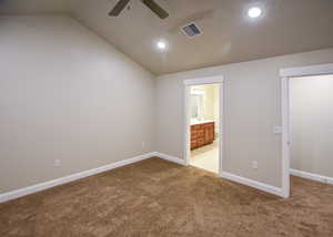 Carpeted spare room with vaulted ceiling and ceiling fan