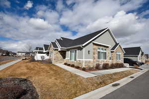 View of side of property with a yard