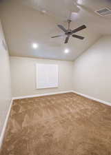 Unfurnished room featuring ceiling fan, carpet flooring, a textured ceiling, and lofted ceiling