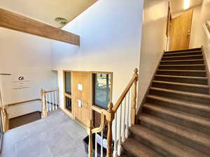 Main level inside entry way, Stairway with a towering ceiling