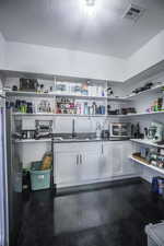 Storage area featuring a sink, visible vents, and a toaster