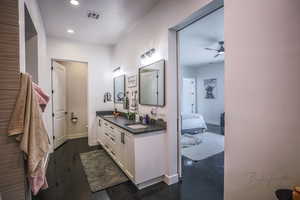 Full bathroom featuring double vanity, recessed lighting, visible vents, a sink, and ensuite bath