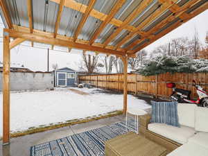 Covered patio looks out fully landscaped backyard and large Tuff shed