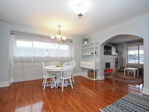 Dining area with chandelier and nice view of engineered hardwood floors