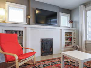 Interior space featuring a healthy amount of sunlight, built in shelves, and tile patterned floors