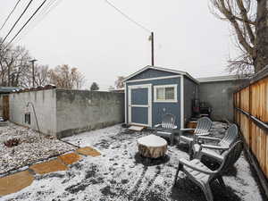 Snow covered stones and chat gravel and a 10'x12' Tuff shed