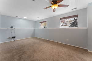 Front room, ceiling fan, and carpet flooring