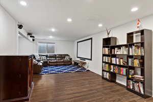 Home theater room featuring dark wood-type flooring and recessed lighting