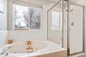 Bathroom with a jetted tub and a stall shower