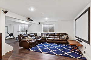 Cinema room with baseboards and wood finished floors