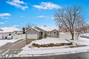 Ranch-style house featuring a garage and stucco siding