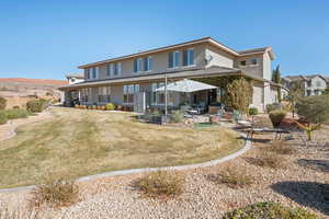 Back of property featuring a patio area and a yard