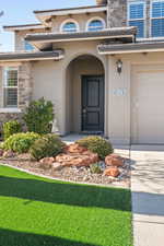 Doorway to property with a garage