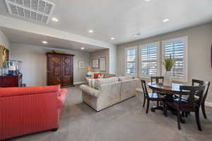 Living room with carpet floors and a textured ceiling