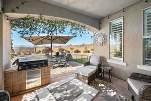 View of patio with a mountain view, area for grilling, and exterior kitchen