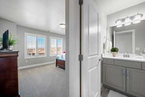 Bathroom with a textured ceiling and vanity