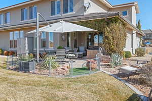 View of front of home featuring a front lawn, exterior kitchen, and a patio area