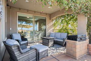 View of patio with area for grilling, a grill, and an outdoor hangout area