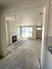 Living room with fireplace, crown molding, nice trim work through out