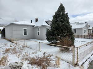 View of snow covered rear of property