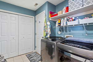 Laundry room with washer and dryer (included!), and light tile patterned flooring