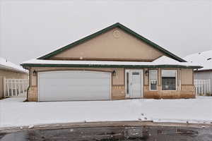 View of front of property with fence and stucco siding