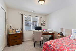 Bedroom with baseboards, and light colored carpet