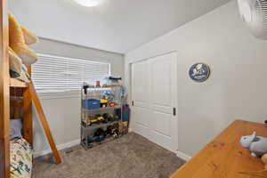 Large Side: Bedroom 2 with a closet, baseboards, and carpet flooring