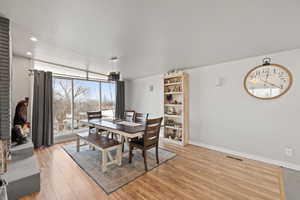 Large Side: Dining area featuring light wood-style flooring, baseboards, and recessed lighting