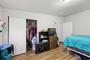 Smaller Side: Bedroom 2 with a closet and wood finished floors