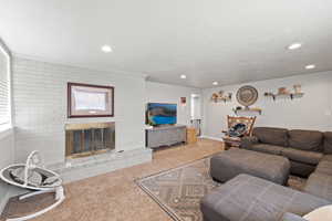 Large Side: Living room featuring carpet floors, recessed lighting, a brick fireplace, and baseboards