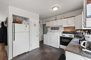 Smaller Side: Kitchen with electric range, washer and dryer, refrigerator, and white cabinetry