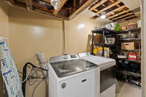 Large Side: Laundry area featuring laundry area and washer and clothes dryer