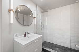 Large Side: Full bathroom with walk in shower and vanity