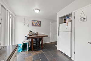 Smaller Side: Dining area with tile flooring