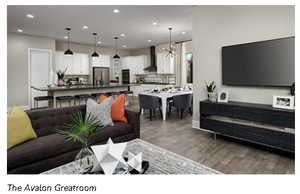 Living area with a notable chandelier, baseboards, wood laminate floors, and recessed lighting