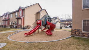 Community jungle gym with a lawn, cooling unit, and a residential view