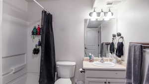 Bathroom with visible vents, vanity, and toilet