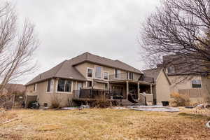 Back of property featuring a patio, a balcony, central air condition unit, fence, and stucco siding