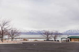 View of road with street lighting and a water and mountain view