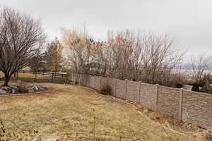 View of yard featuring fence