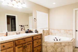 Bathroom featuring a bath and vanity