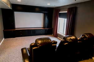 Cinema room featuring recessed lighting, baseboards, and light colored carpet