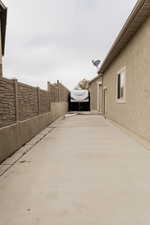 View of home's exterior with fence, a patio, and stucco siding