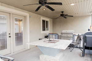 View of patio / terrace with exterior kitchen, exterior bar, and a ceiling fan