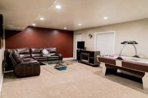 Living room featuring recessed lighting, light carpet, and baseboards