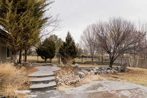 View of yard featuring a fenced backyard and a patio