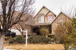 View of front of property with stone siding and an attached garage