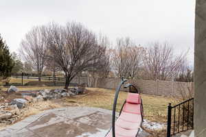 View of yard with a fenced backyard and a patio